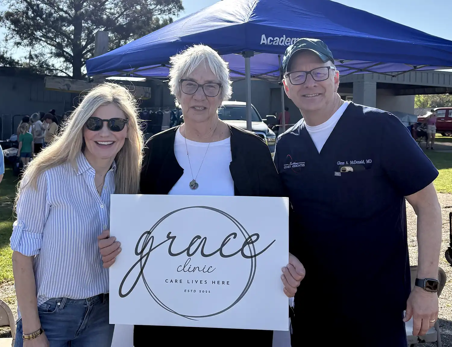 Leslie Goudarzi, Deborah Bell, and Glenn McDonald holding a Grace sign